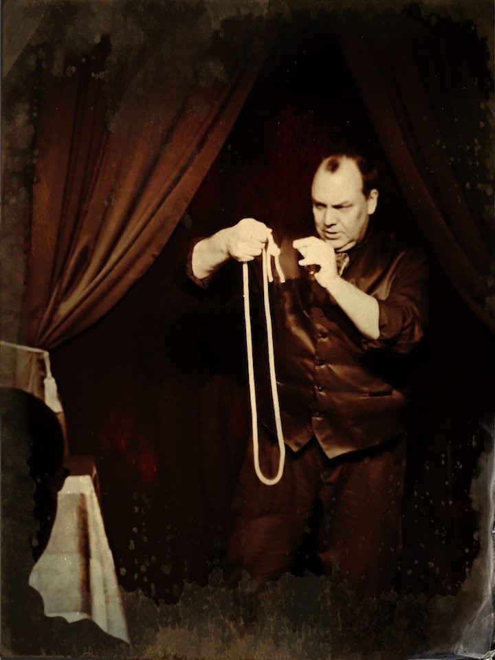 Dean Carnegie in Victorian dress, performing with a rope